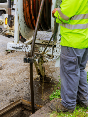 Machine for cleaning sewer wells in the a town street.